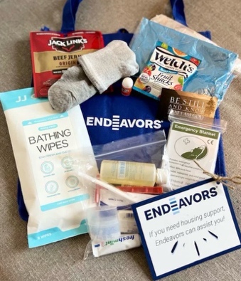 A care kit with hygiene products, snacks, and essentials for someone experiencing homelessness